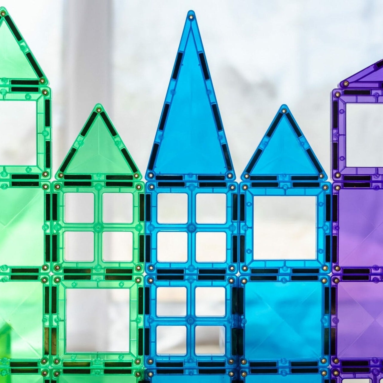 Children building structures with Connetix magnetic tiles