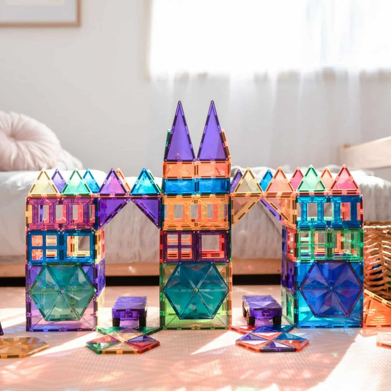 Children building structures with Connetix magnetic tiles