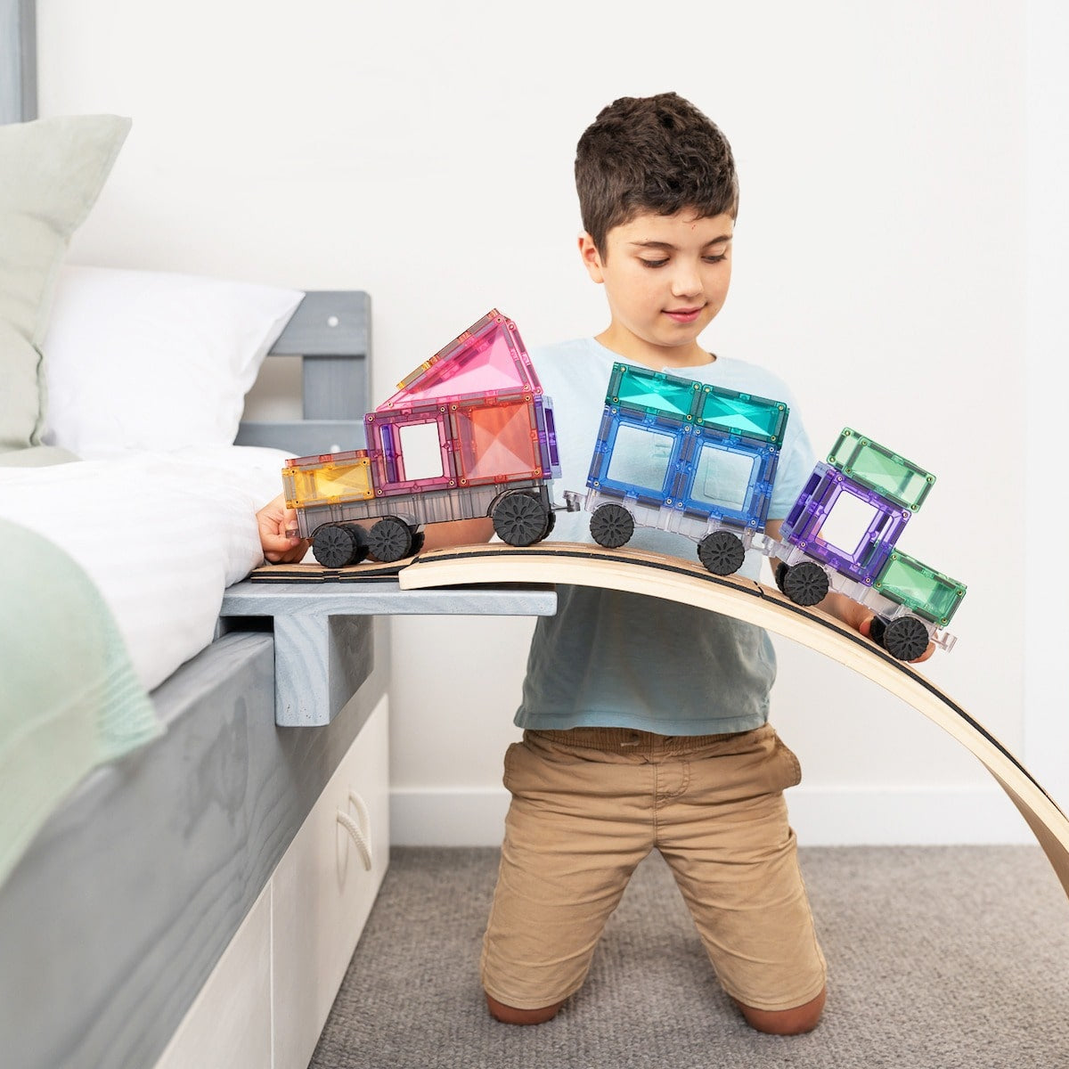 Children playing with Connetix Pastel Transport Pack – magnetic car and train pieces in action"