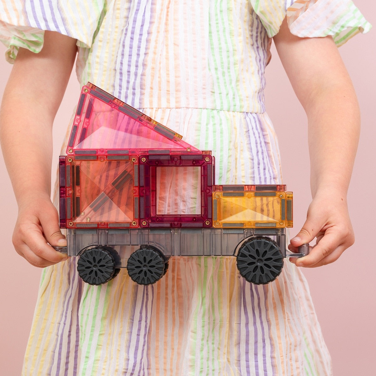Children playing with Connetix Pastel Transport Pack – magnetic car and train pieces in action