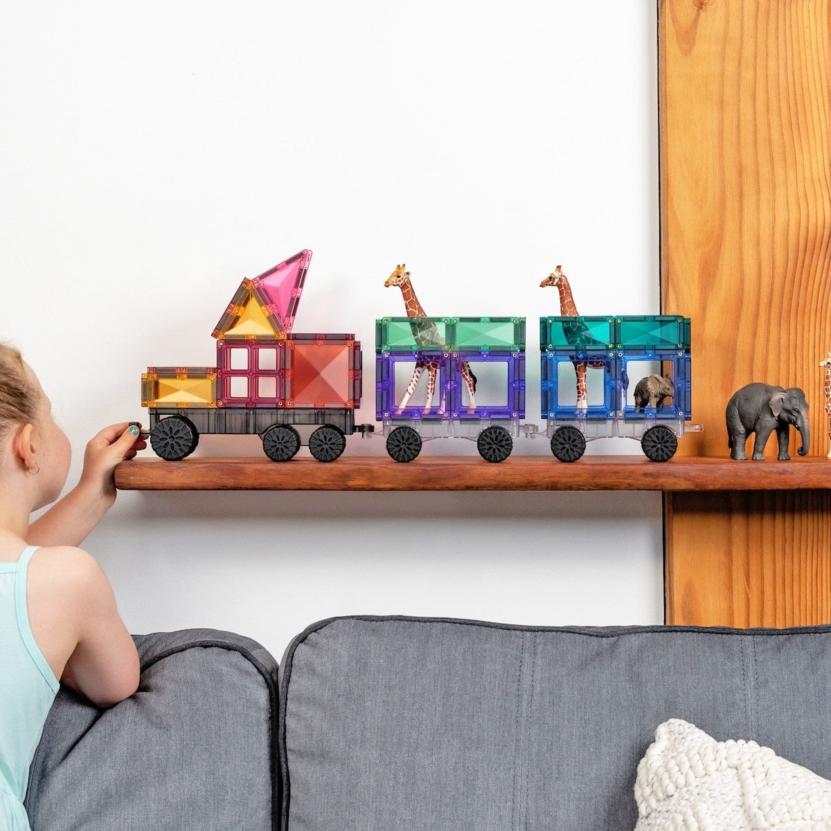 Children playing with Connetix Pastel Transport Pack – magnetic car and train pieces in action