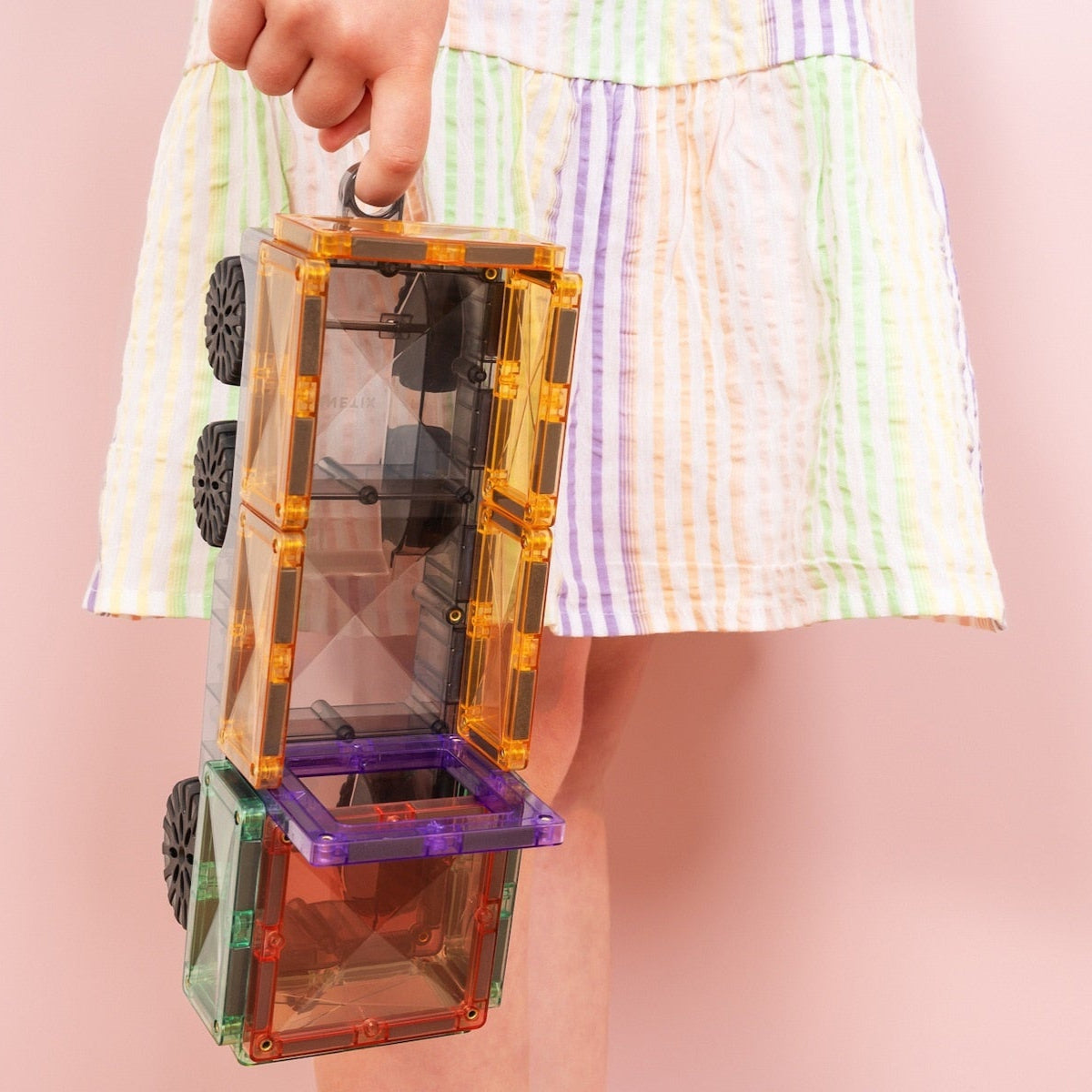 Children playing with Connetix Pastel Transport Pack – magnetic car and train pieces in action"