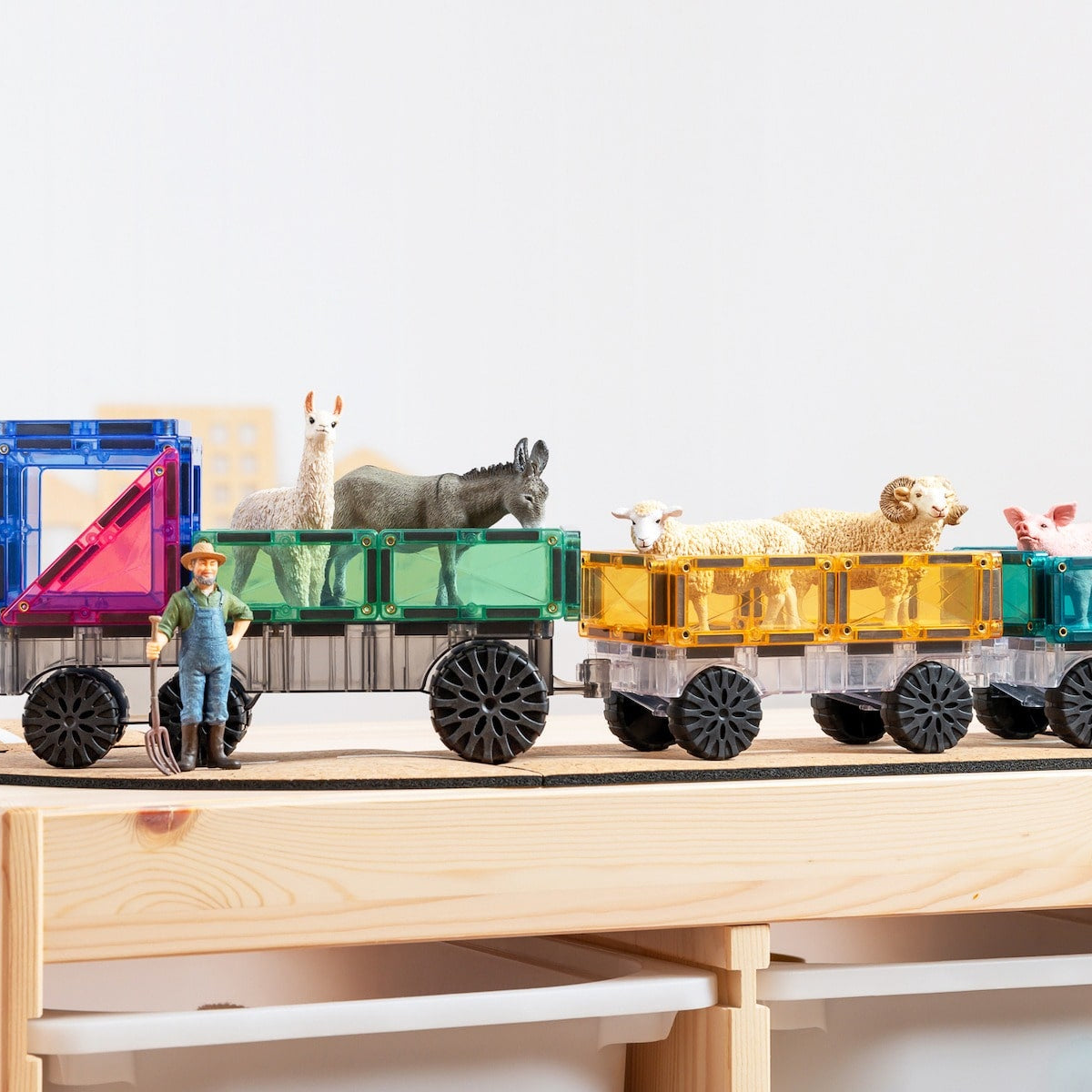 Children playing with Connetix Pastel Transport Pack – magnetic car and train pieces in action"