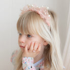Side view of Ava Ballerina Pearl Headband by Lauren Hinkley showing pearl design and comfortable fit