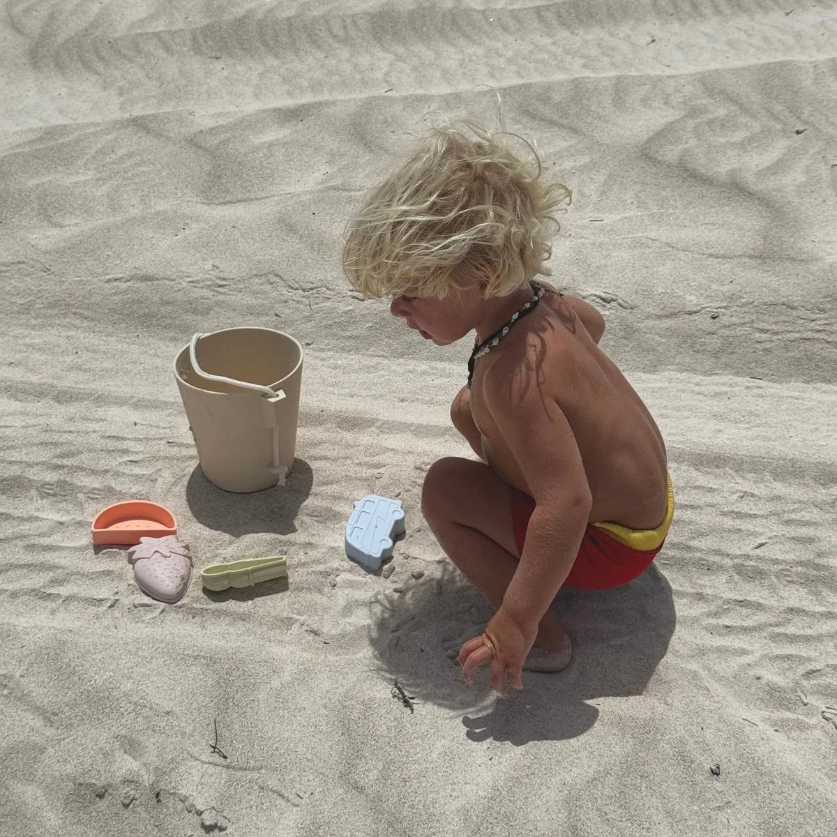 Apple Sorbet silicone bucket and spade from Sunnylife for kids beach and sand play