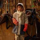 Child wearing Crywolf Ash Colourblock rain jacket outdoors