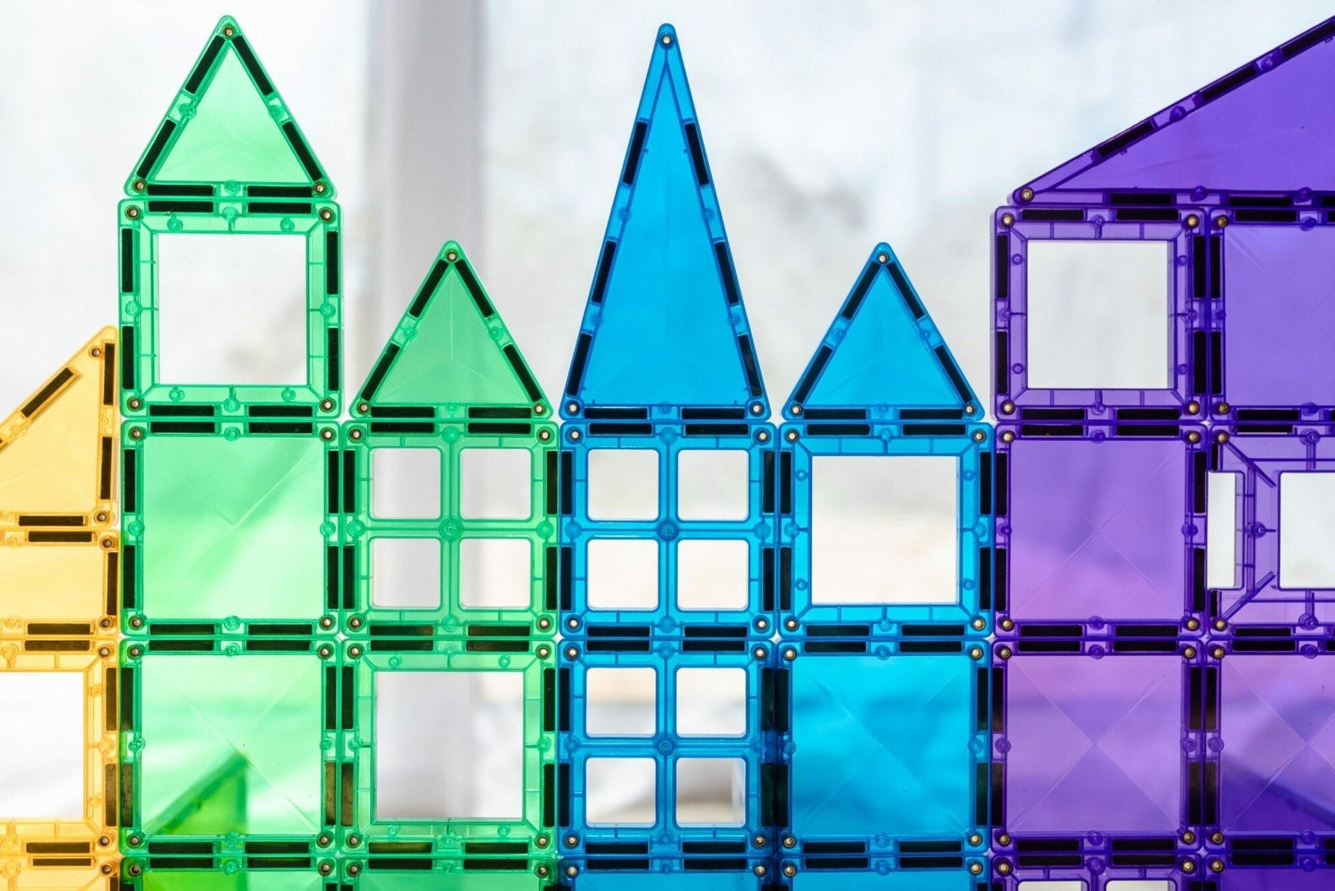 Children building structures with Connetix magnetic tiles
