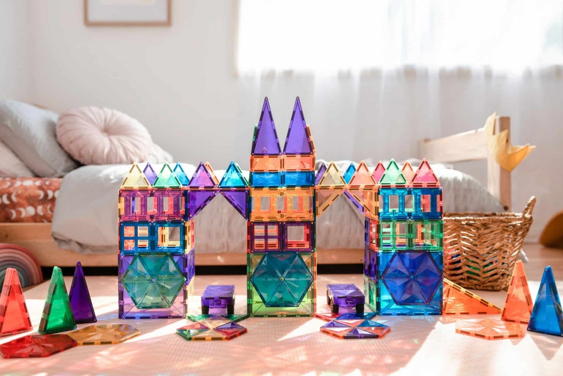 Children building structures with Connetix magnetic tiles