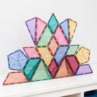 Assorted Connetix pastel magnetic tile shapes including pentagons, triangles, and trapezoids