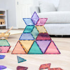 Assorted Connetix pastel magnetic tile shapes including pentagons, triangles, and trapezoids