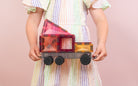 Children playing with Connetix Pastel Transport Pack – magnetic car and train pieces in action
