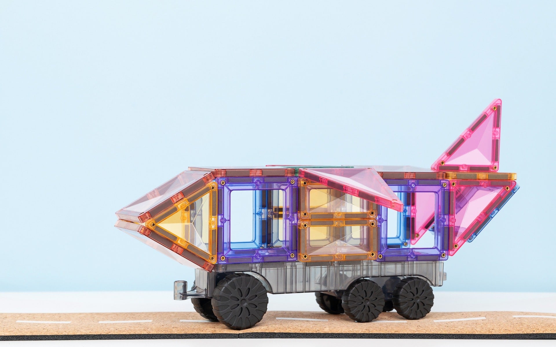 Close-up of pastel-coloured magnetic tiles and vehicle bases from Connetix Transport Pack