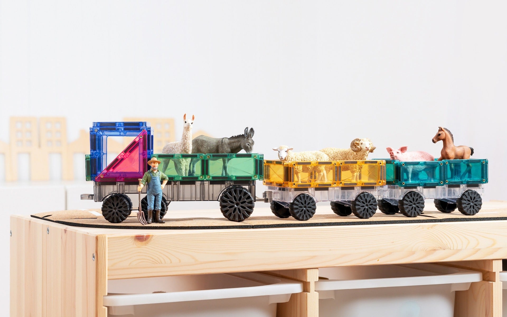 Children playing with Connetix Pastel Transport Pack – magnetic car and train pieces in action"