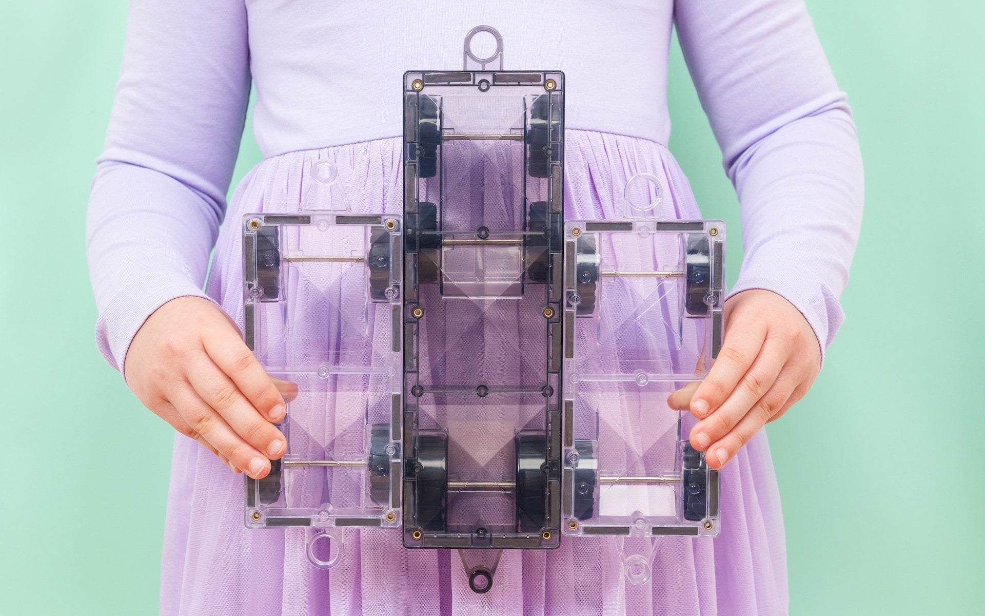 Children playing with Connetix Pastel Transport Pack – magnetic car and train pieces in action"