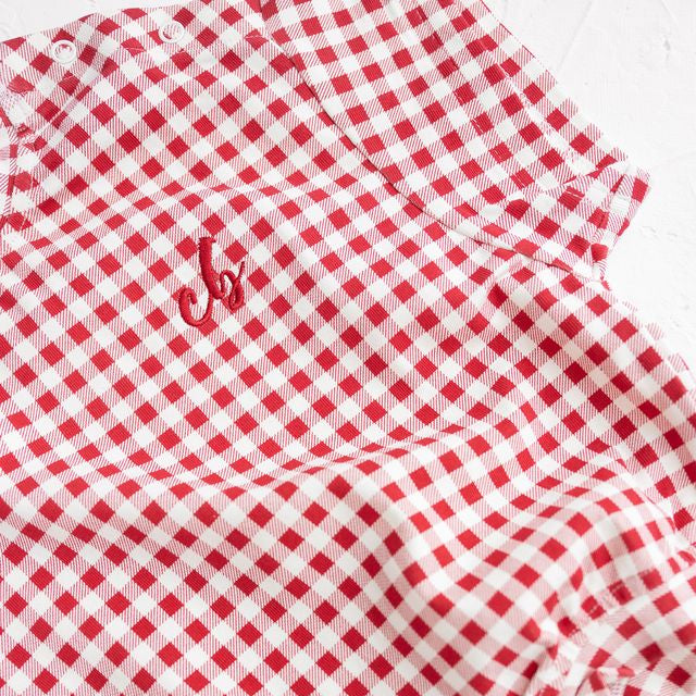 Red and white checkered baby romper with a logo on a white background