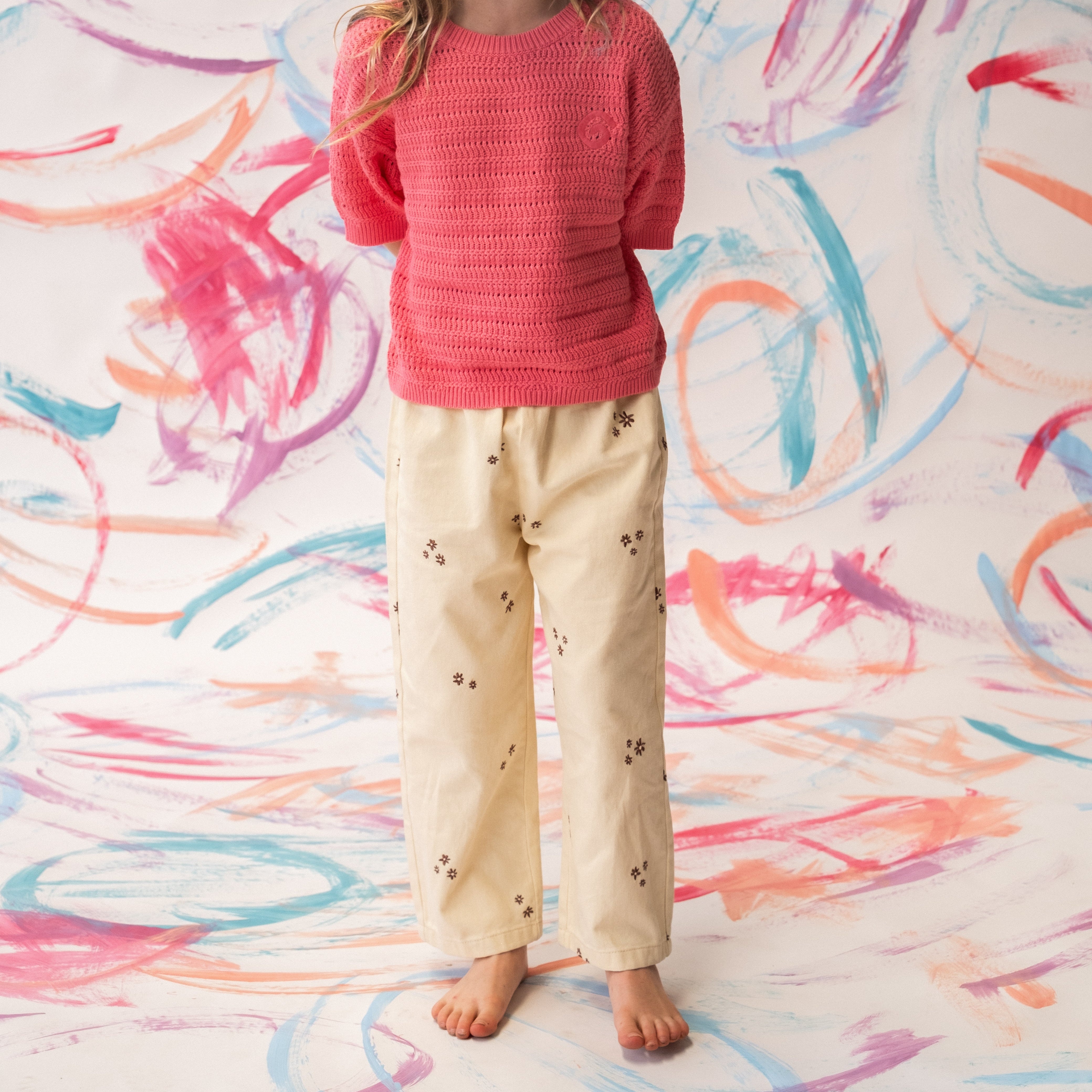 Organic denim pants in Milk with wild flower embroidery, front view