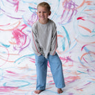 Exposed seam detail at sleeve head on grey marle long sleeve tee