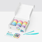 Box of colorful hey clay with a tool on a white background