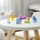 Colorful unicorn figurines made with hey clay unicorn set on a white table 