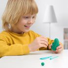 Child playing with green play hey clay creating hey clay monster 