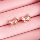 Lauren Hinkley Pink Bow Earrings with sparkling diamantes and gold accents – sterling silver posts for kids, closeup.