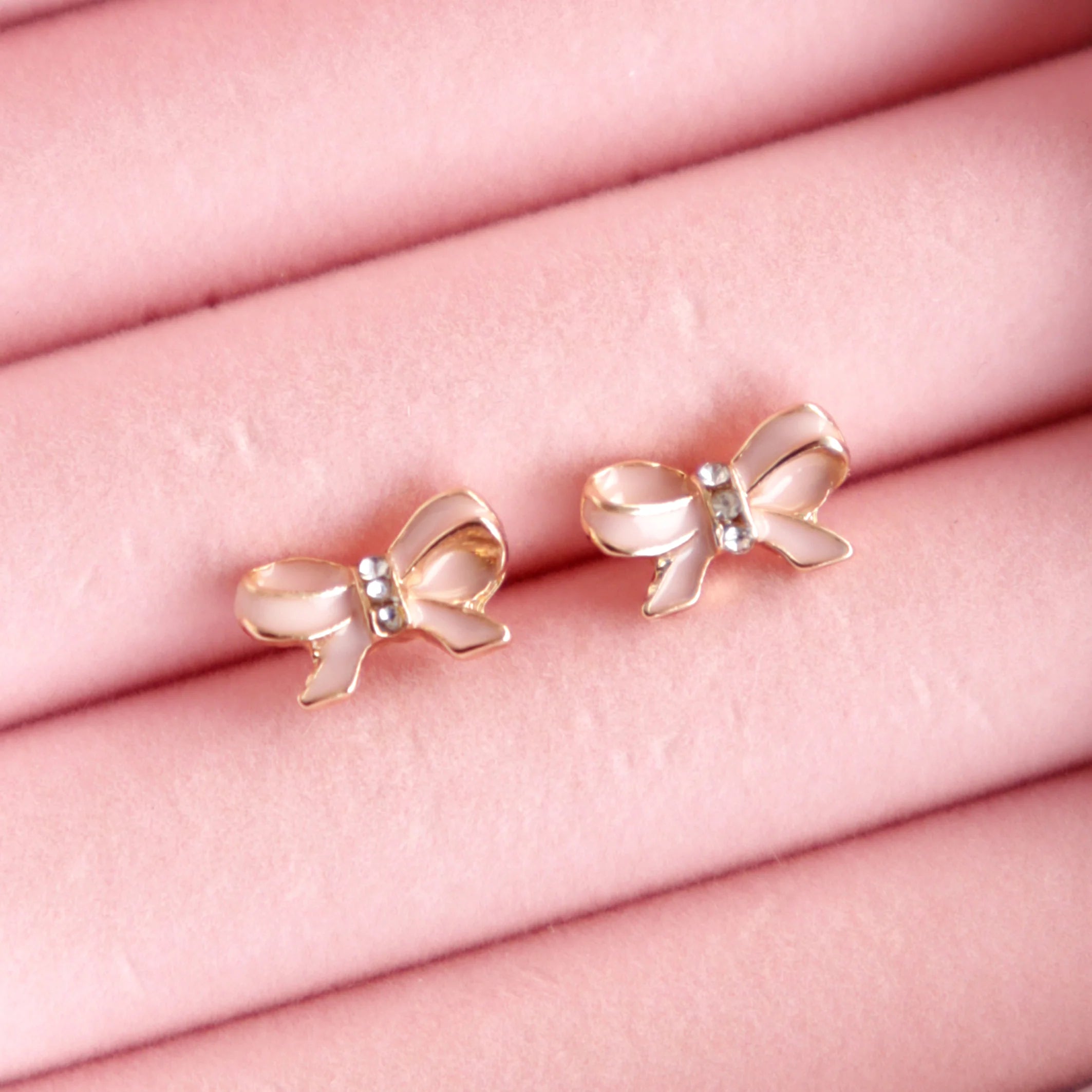 Lauren Hinkley Pink Bow Earrings with sparkling diamantes and gold accents – sterling silver posts for kids, closeup.