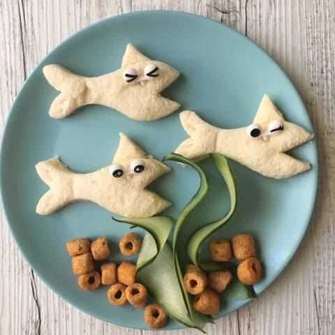 Lunch Punch Mermaid Cutter in use making a sandwich with shark cutter