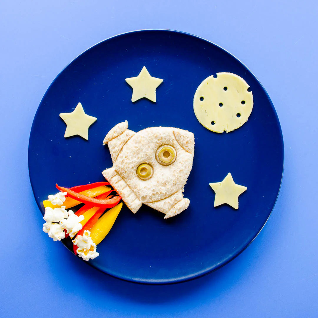 Styled lunch with sandwiches cut using Lunch Punch rocket ship on dinner plate 