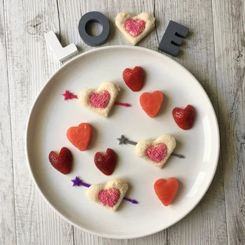Magical unicorn and heart-shaped sandwiches on a lunch plate