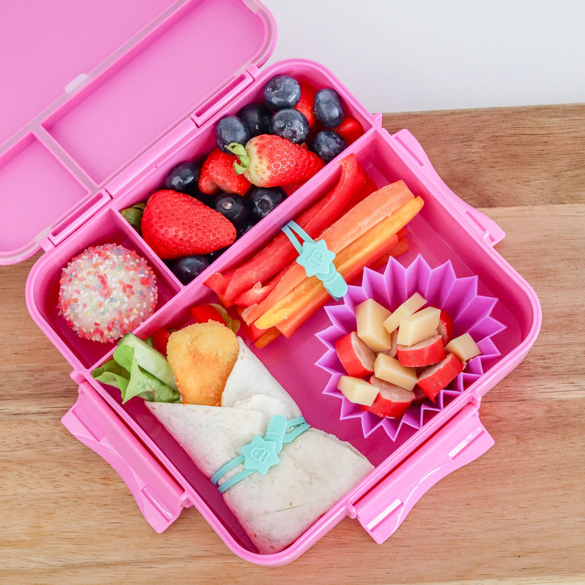 Inside view of MontiiCo Bento Three Floss lunchbox showing three leakproof compartments