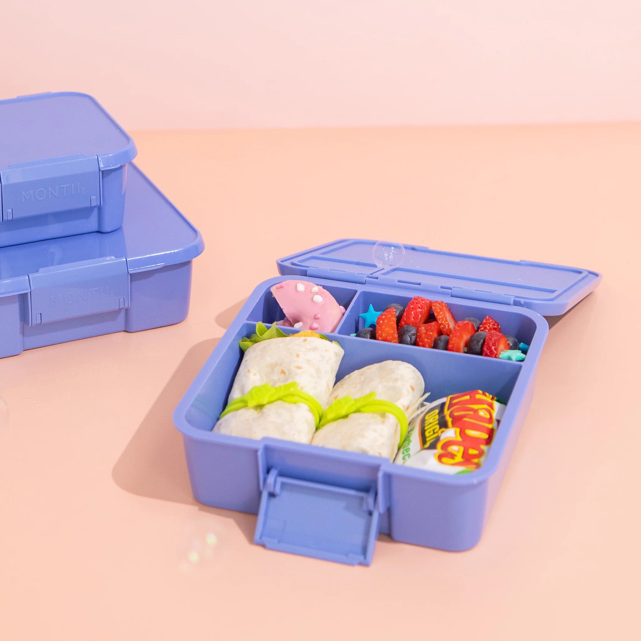 MontiiCo Bento Three Splash lunchbox open showing three compartments and easy-open latch